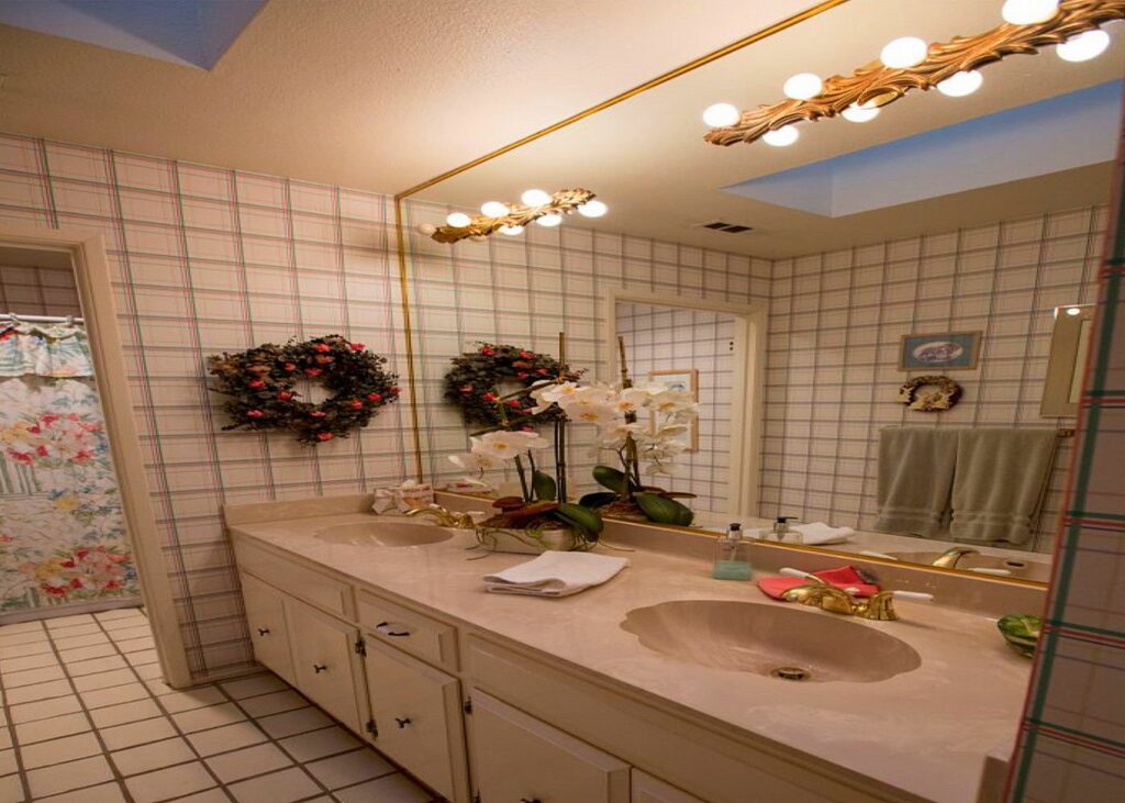 Dated bathroom with original tile and vanity before renovation