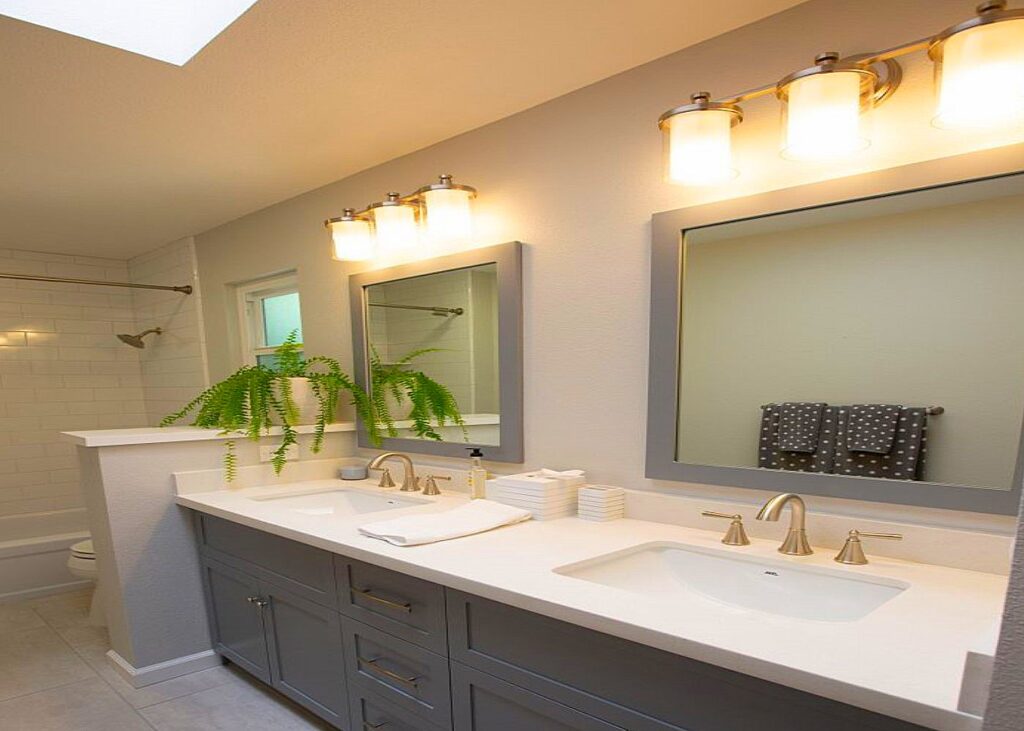 Same bathroom after renovation with new vanity, lighting and finishes