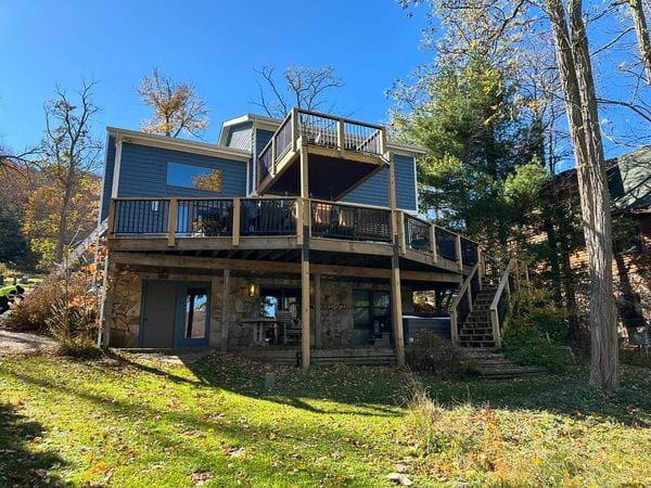Multi-level deck on a hillside lake home, built and roofed by Peak Precision Contracting