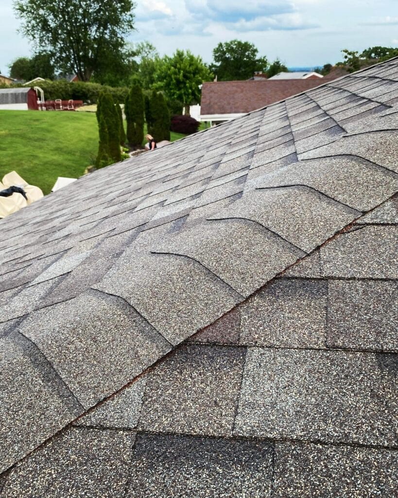 New driftwood-color architectural shingle roof on a home in a residential neighborhood