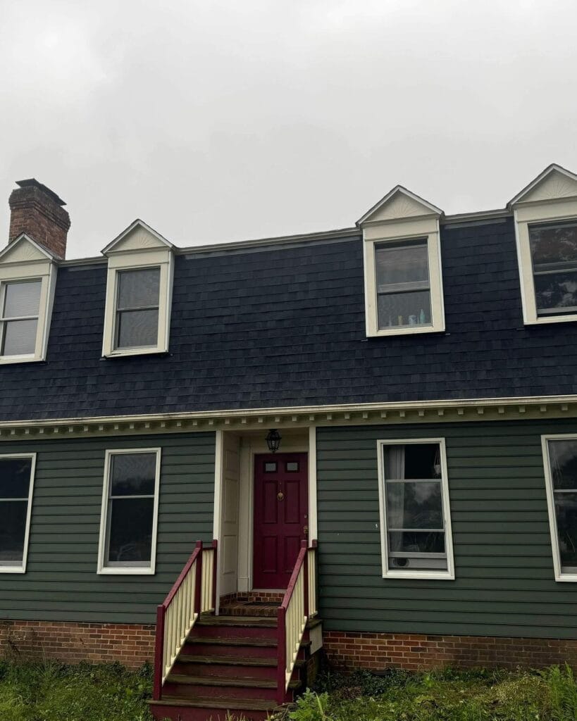 Colonial home with a new black shingle roof and dormers, completed by Peak Precision Contracting