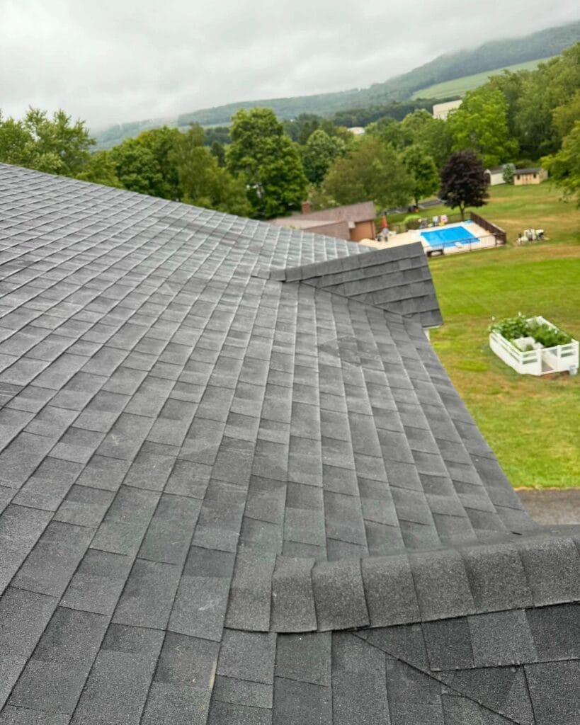 Steep roof slope with new black architectural shingles