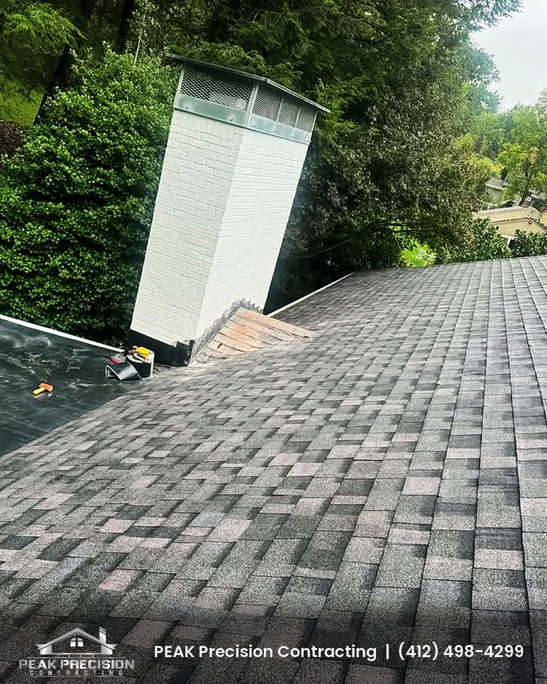 New shingle roof meeting a chimney and low-slope section on a South Hills PA home, the detail area where chimney flashing leaks often start