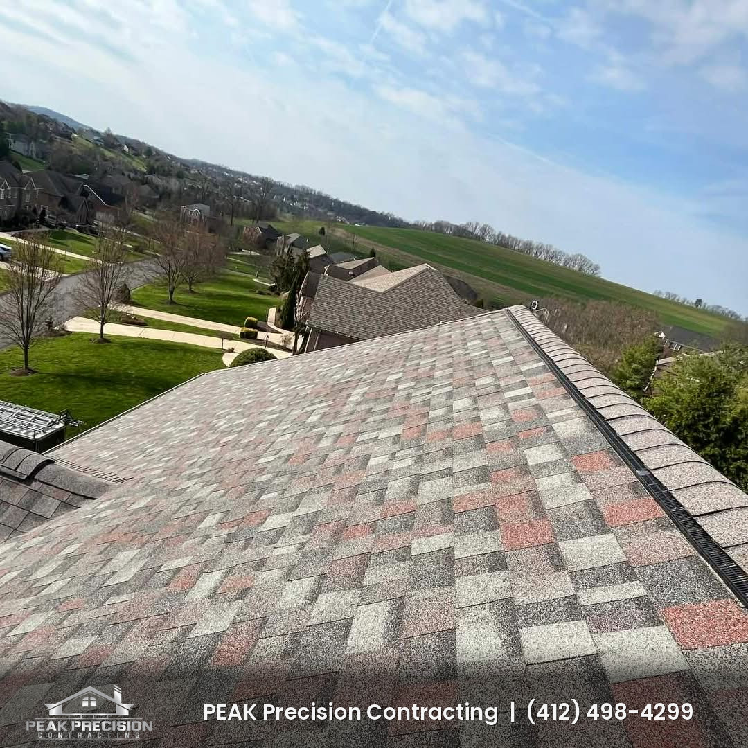 Completed Owens Corning shingle roof with ridge vent and ridge cap, installed by Peak Precision Contracting