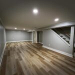 Finished basement with recessed lighting and vinyl plank flooring by Peak Precision Contracting in Peters Township, PA