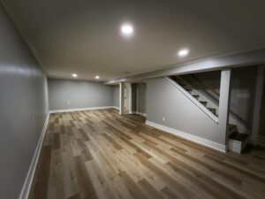 Finished basement with recessed lighting and vinyl plank flooring by Peak Precision Contracting in Peters Township, PA