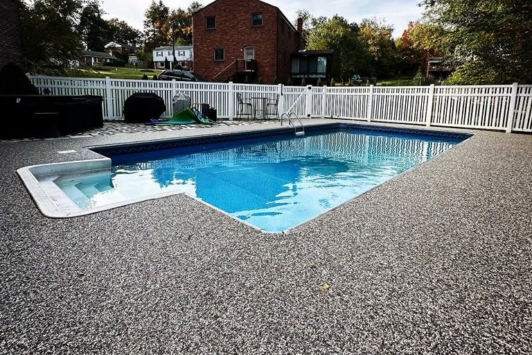 peak-precision-exposed-aggregate-pool-deck-card-1 Exposed aggregate concrete pool deck around an in-ground pool by Peak Precision Contracting