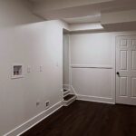 Freshly painted laundry area and hallway with white trim by Peak Precision Contracting