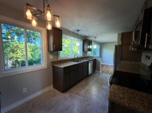 Kitchen remodel by Peak Precision Contracting in Peters Township, PA with dark wood cabinets, granite countertops and tile flooring