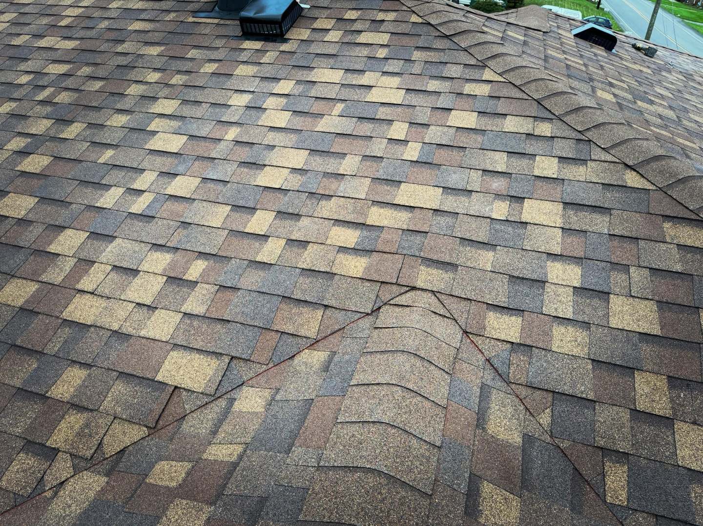 Ridge and vent detail on a roof replaced by Peak Precision Contracting