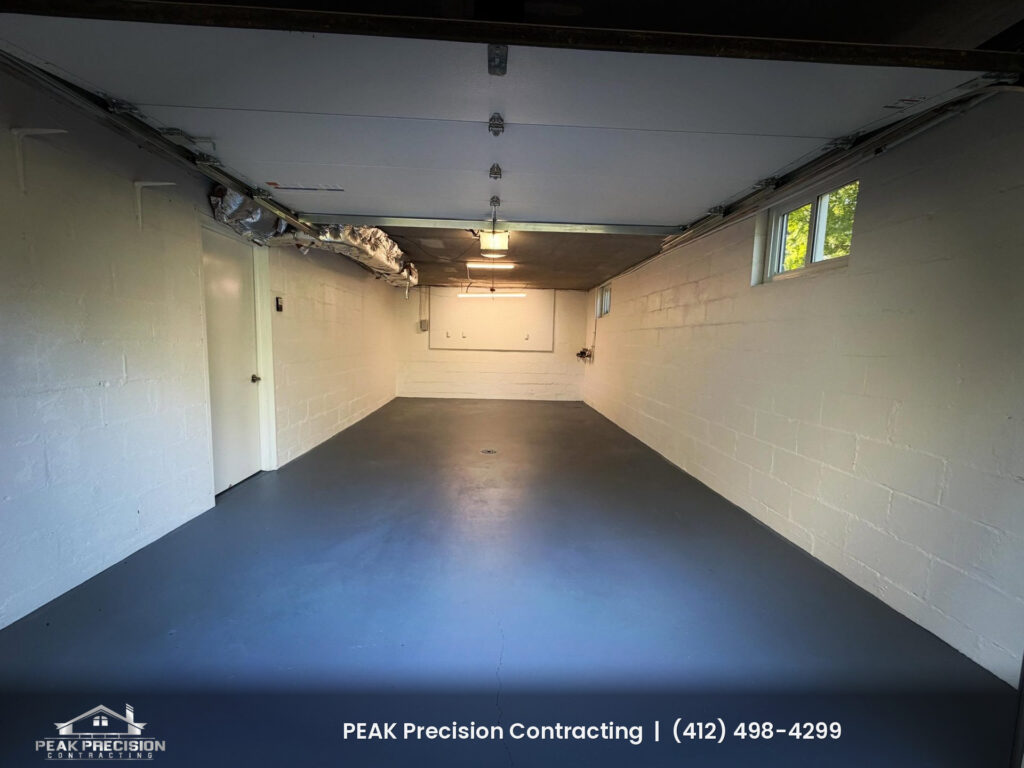 winter-interior-painting-cecil-township-pa_garage Garage interior with freshly painted white block walls and a gray painted concrete floor, finished by Peak Precision Contracting